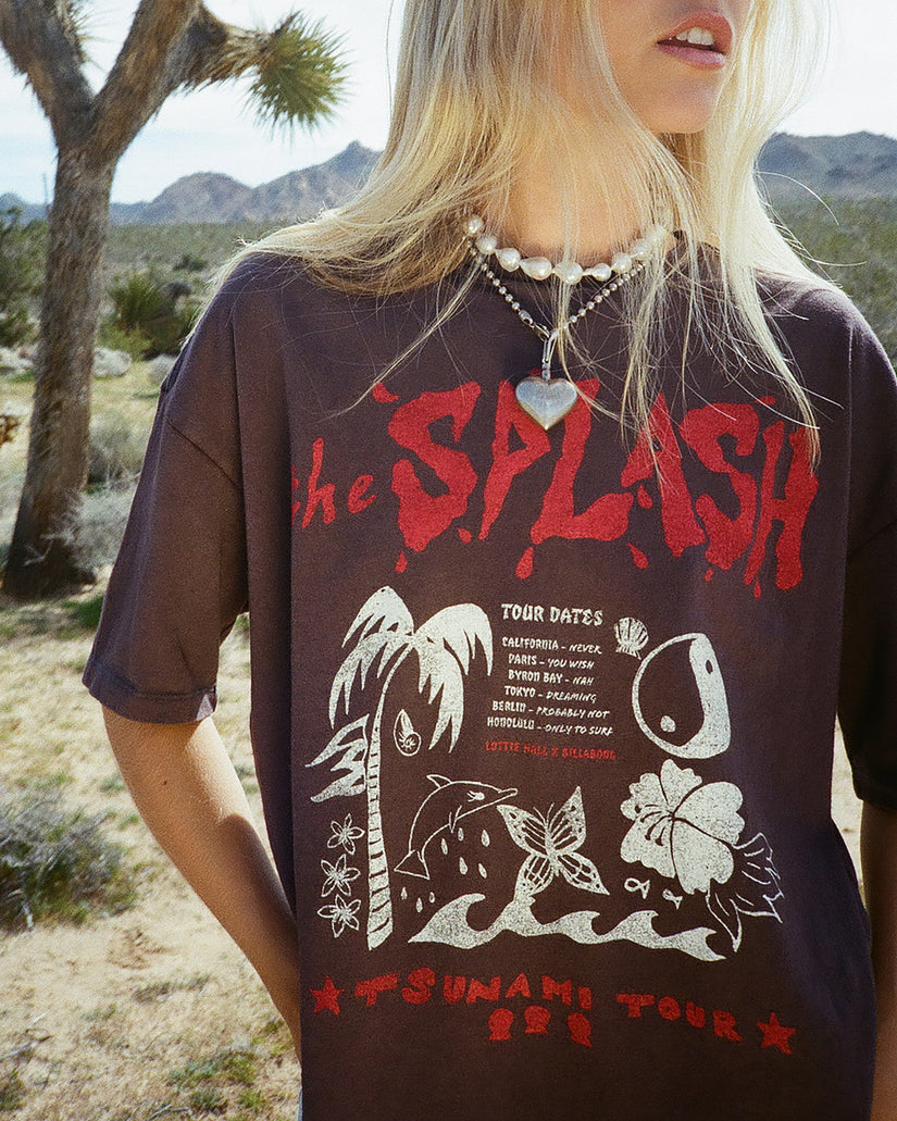 Off-black short sleeve t-shirt with red and white tour graphic print featuring text and illustrated design elements.