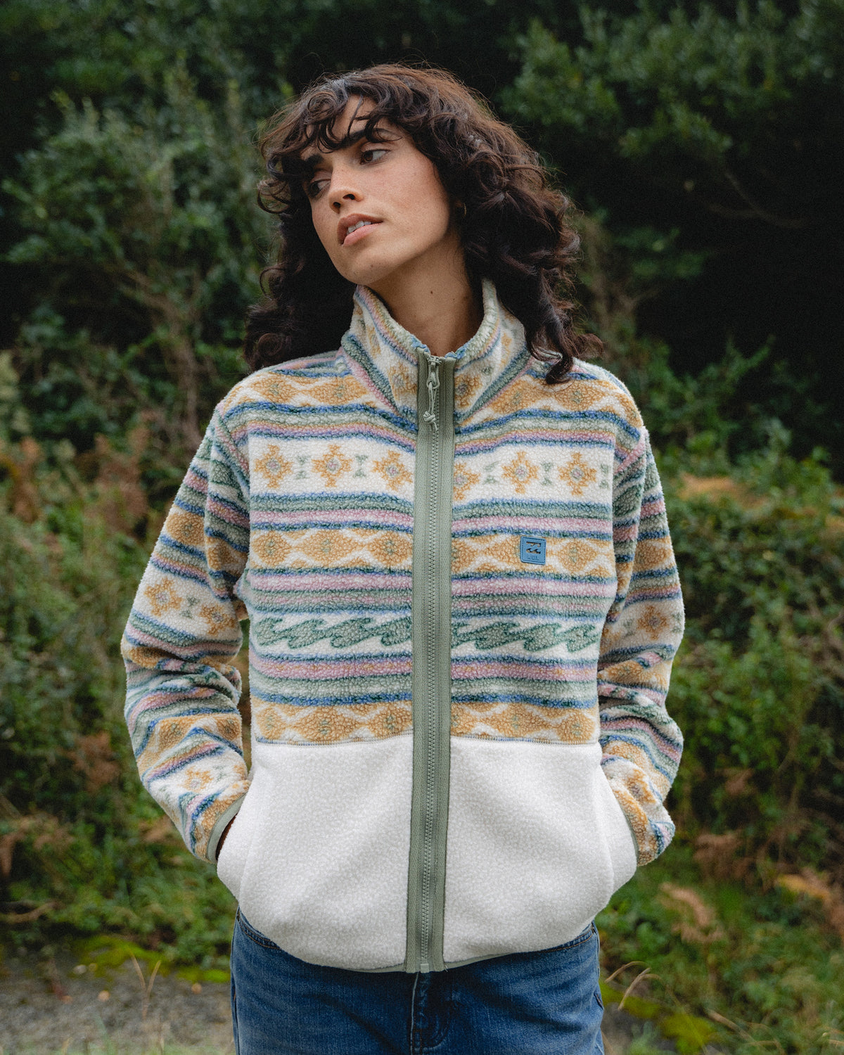 White and multicolored striped sherpa fleece jacket with mock neck and full-length zip.