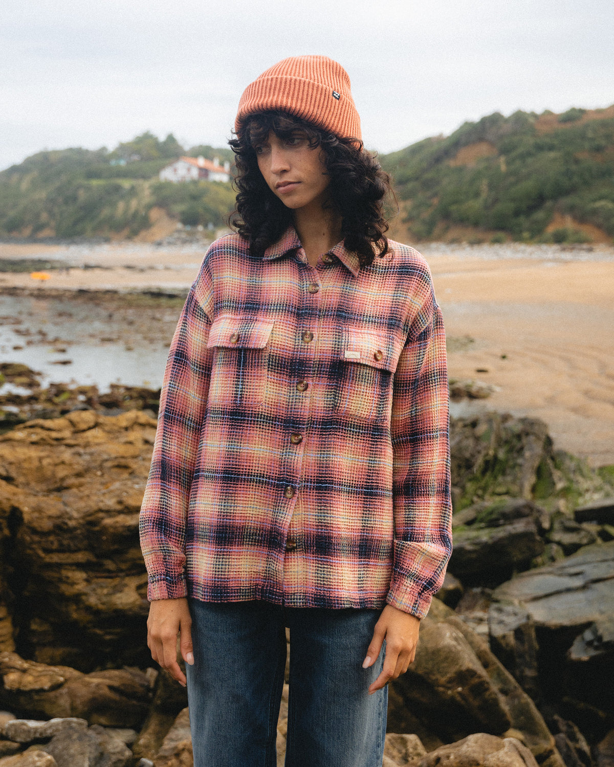 Mountain rose plaid long sleeve shirt with button front and chest pockets worn with jeans.