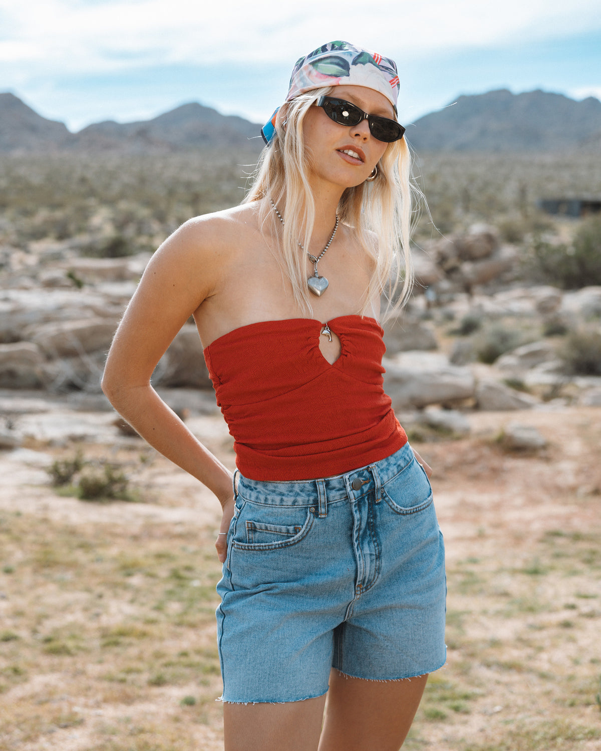 Faded indigo denim cut-off shorts with frayed edges and a high waistline.