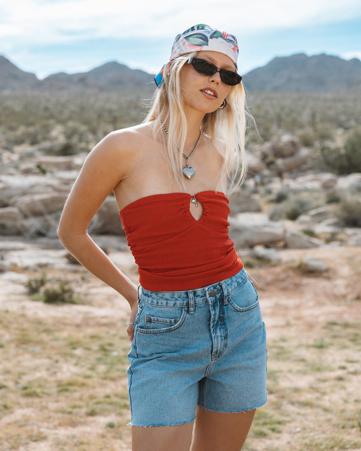 True red strapless tube top with ruched front and heart cutout detail.