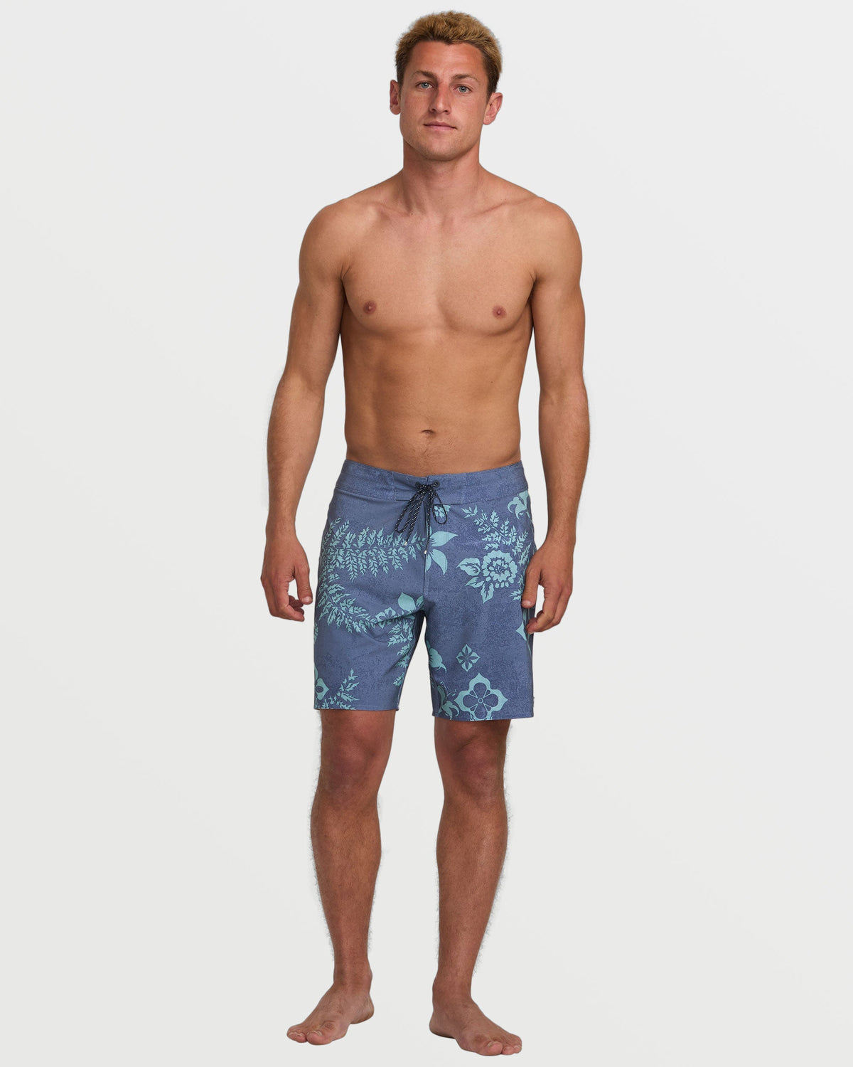 Man wearing blue boardshorts with floral pattern and drawstring waistband.