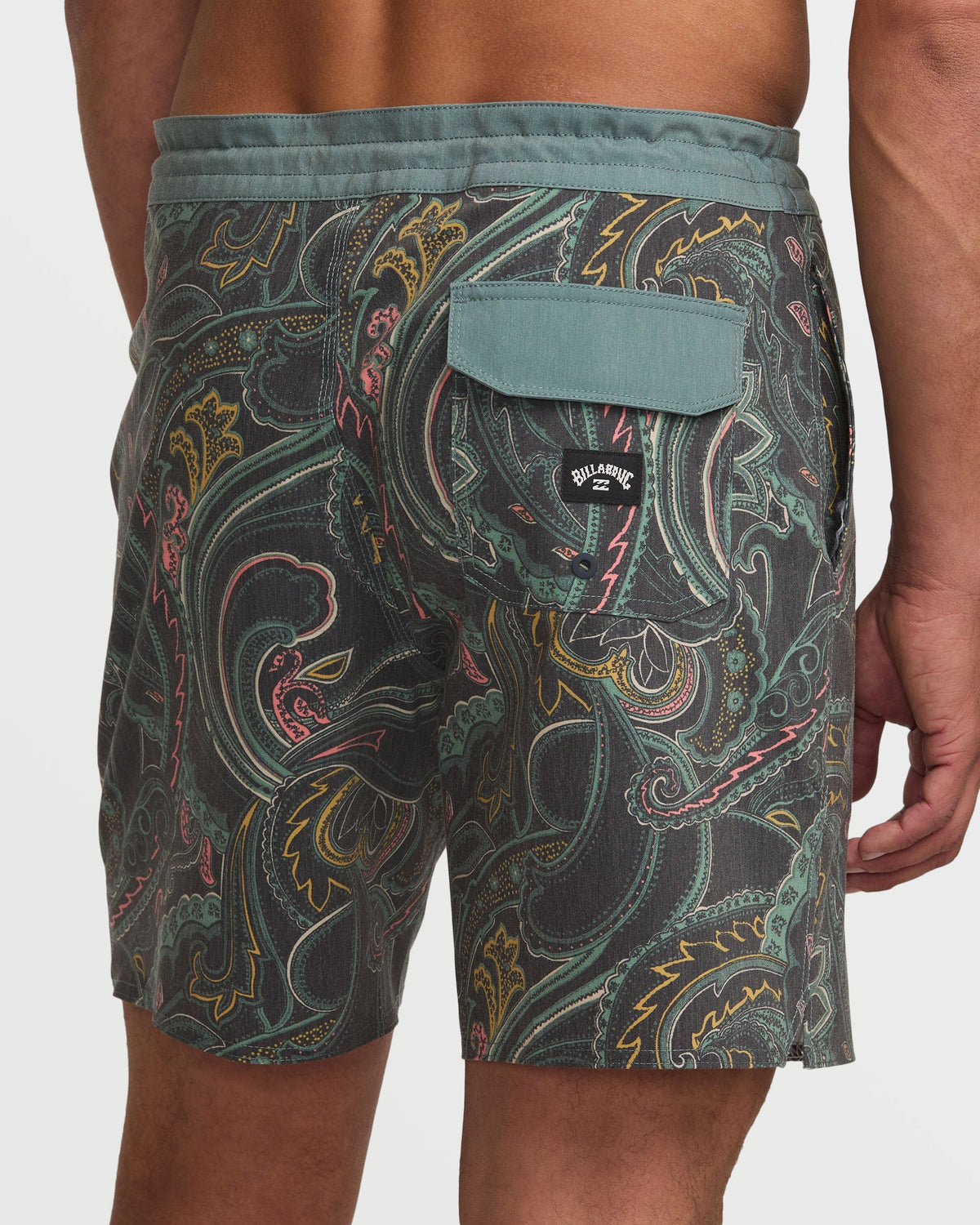 Dark slate boardshorts with multicolored paisley and floral print design, featuring a solid waistband and back pocket.