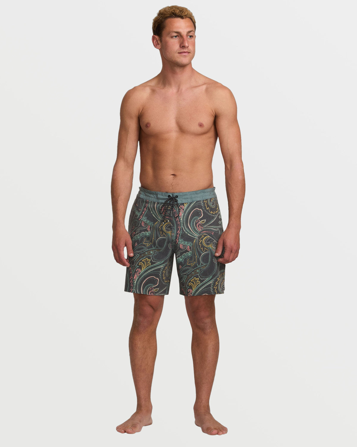 Dark slate boardshorts with multicolored swirl pattern, drawstring waist, knee-length cut on male model.