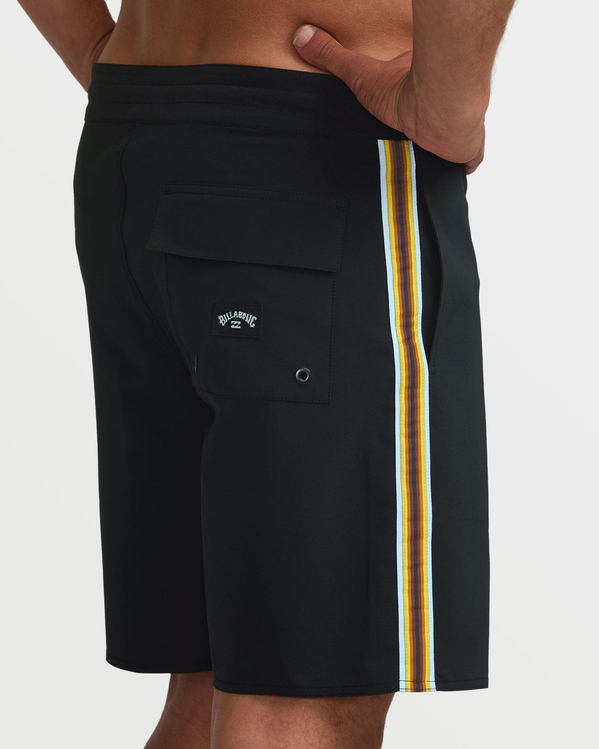Black boardshorts with yellow and white striped side seam, cargo pocket, and Billabong logo.