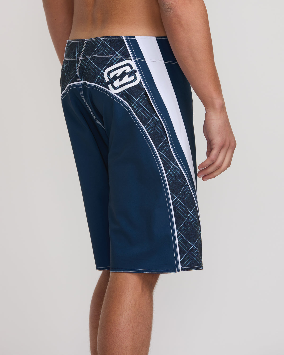 Midnight navy boardshorts with quilted panel, white stripe, and logo patch on side seam.