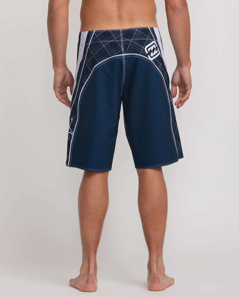 Midnight blue boardshorts with white geometric pattern on waistband and side panels, shown on male model from waist down.