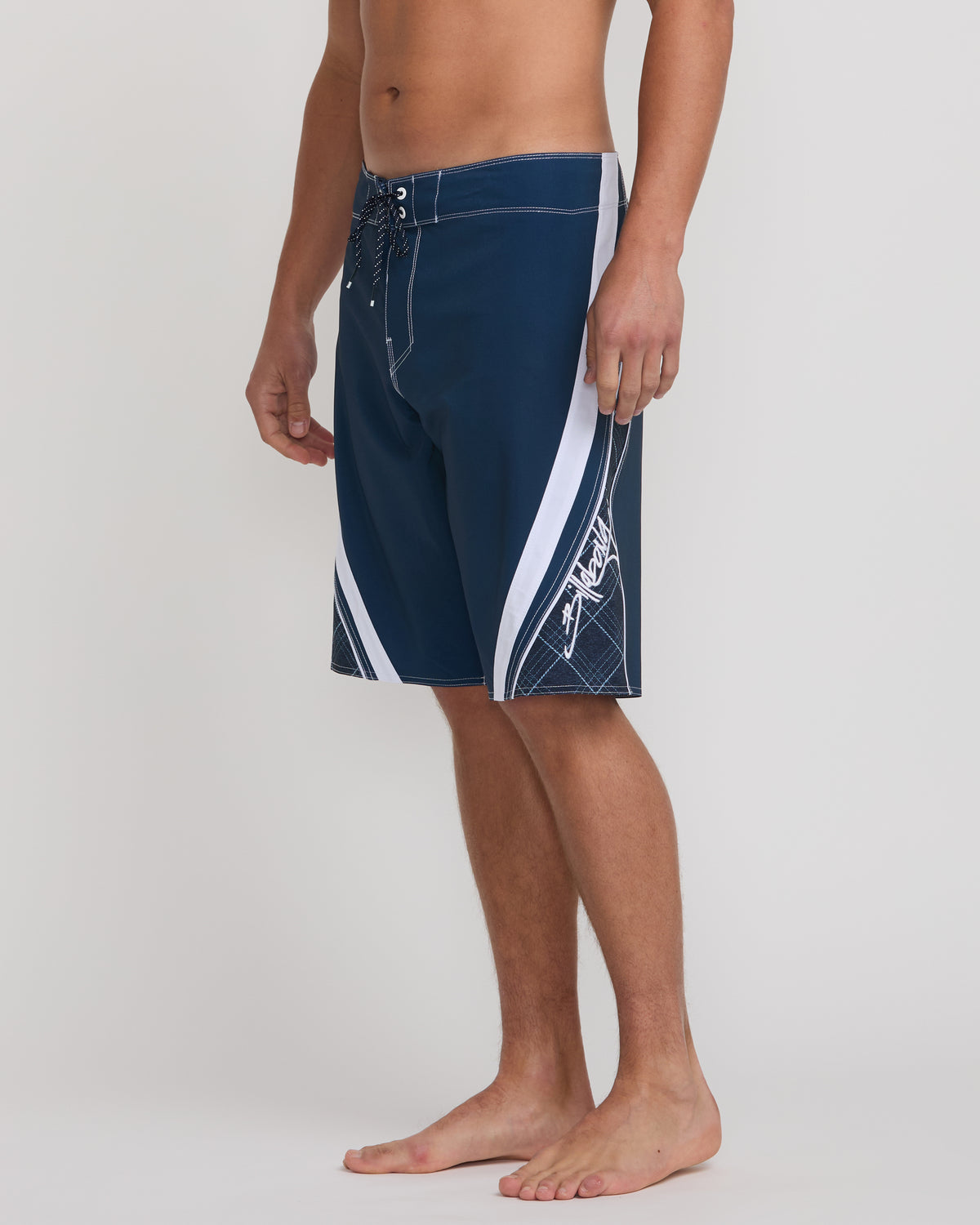 Midnight blue boardshorts with white side stripes and drawstring waistband, worn by male model.