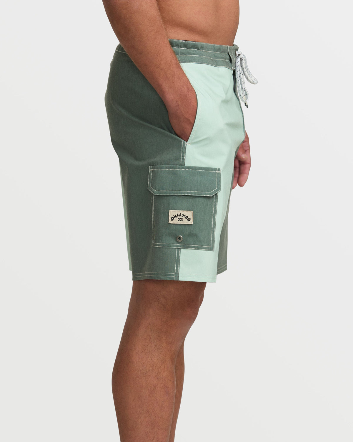 Men's boardshorts in dark green and light green color-block design with cargo pocket and drawstring waist.