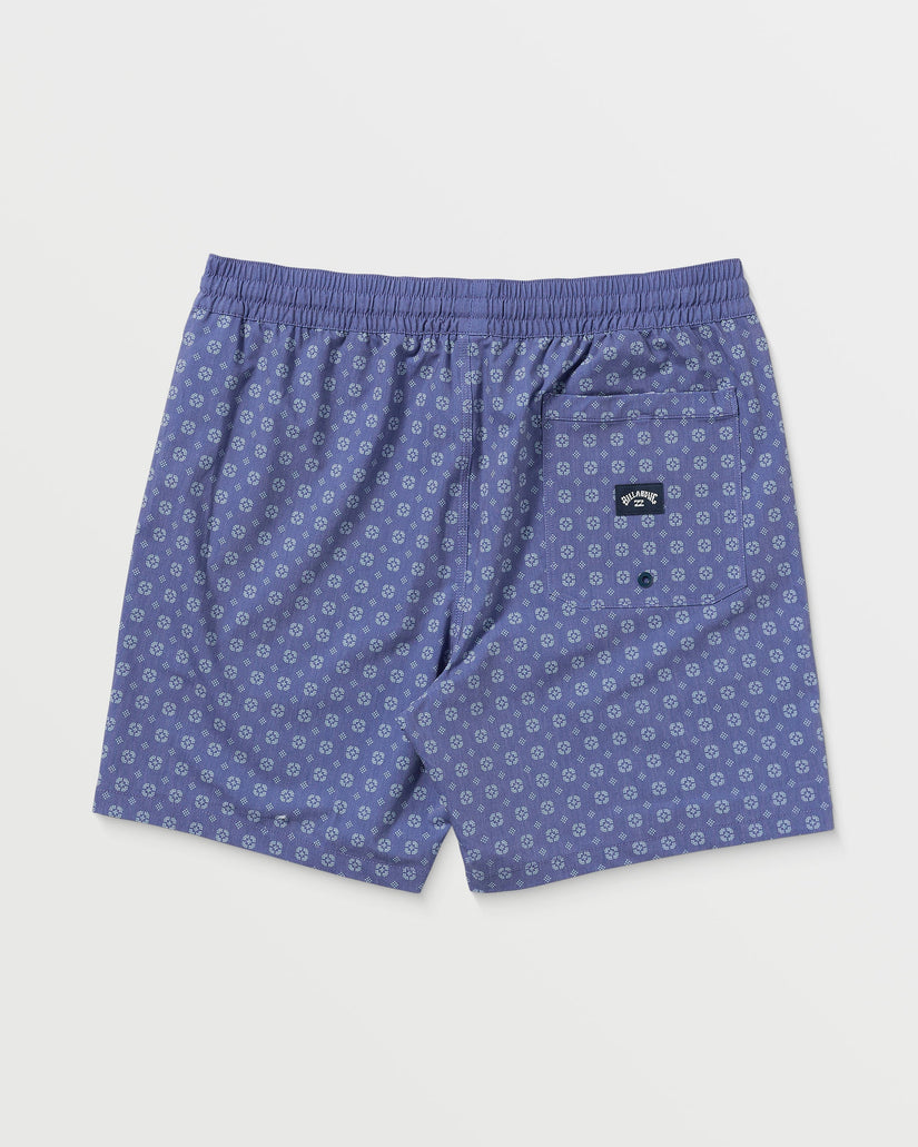 Deep blue swim trunks with small geometric print, elastic waistband, and back pocket patch.