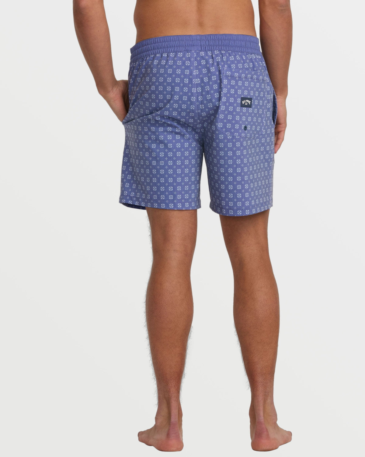Deep blue swim trunks with small circular geometric pattern and elastic waistband, shown from back view.