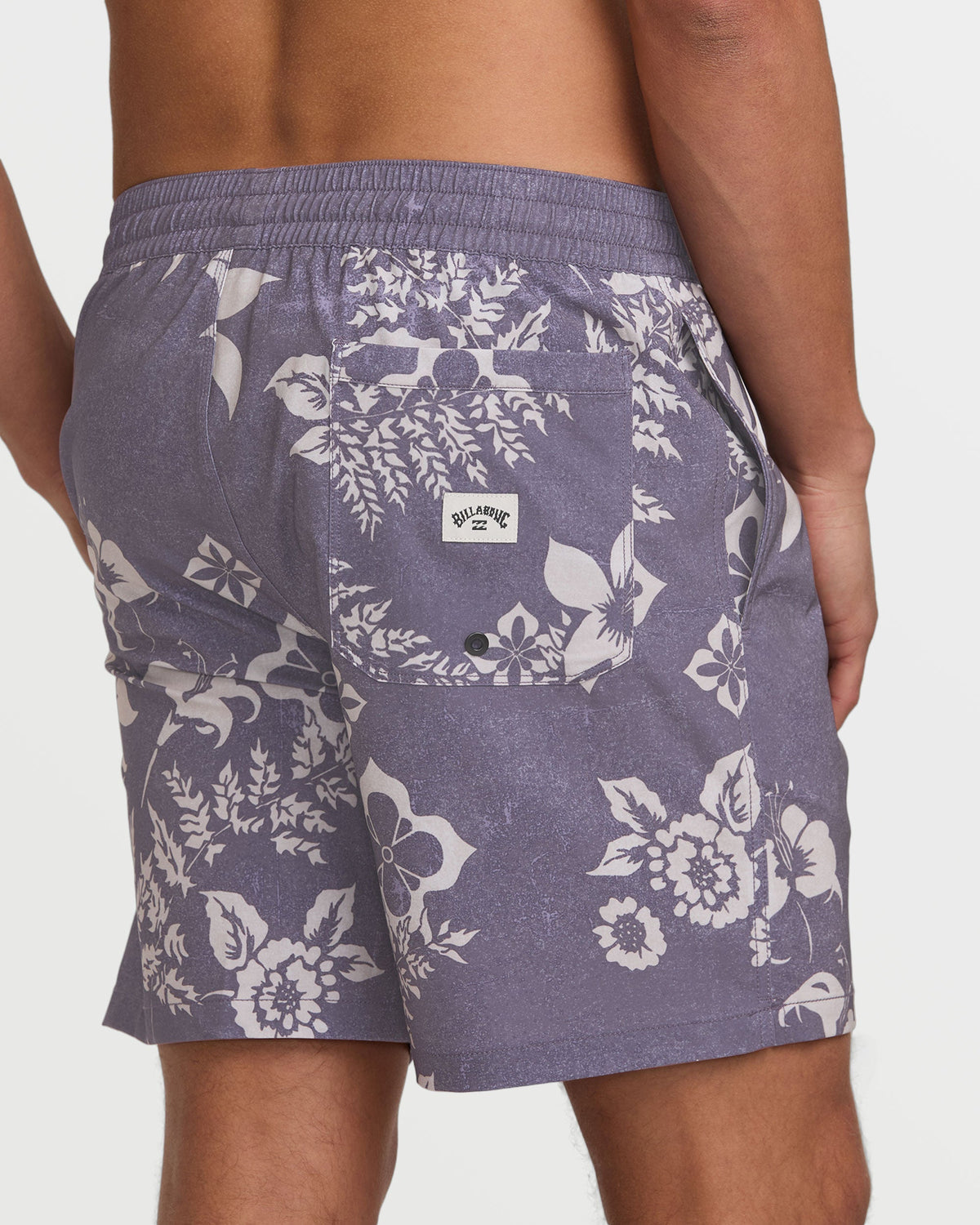 Light purple swim trunks with white floral print, elastic waistband, and back pocket with brand label.