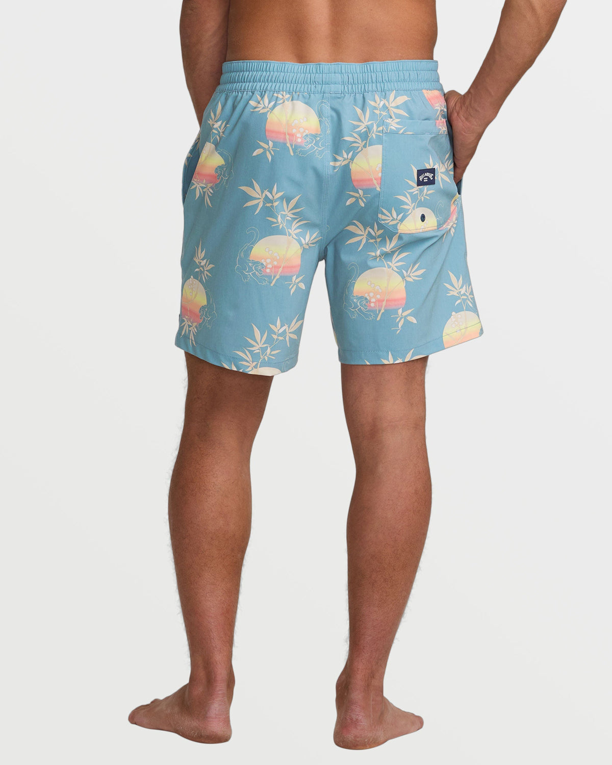 Washed blue swim trunks with sunset and bamboo leaf print, elastic waistband, back pocket.