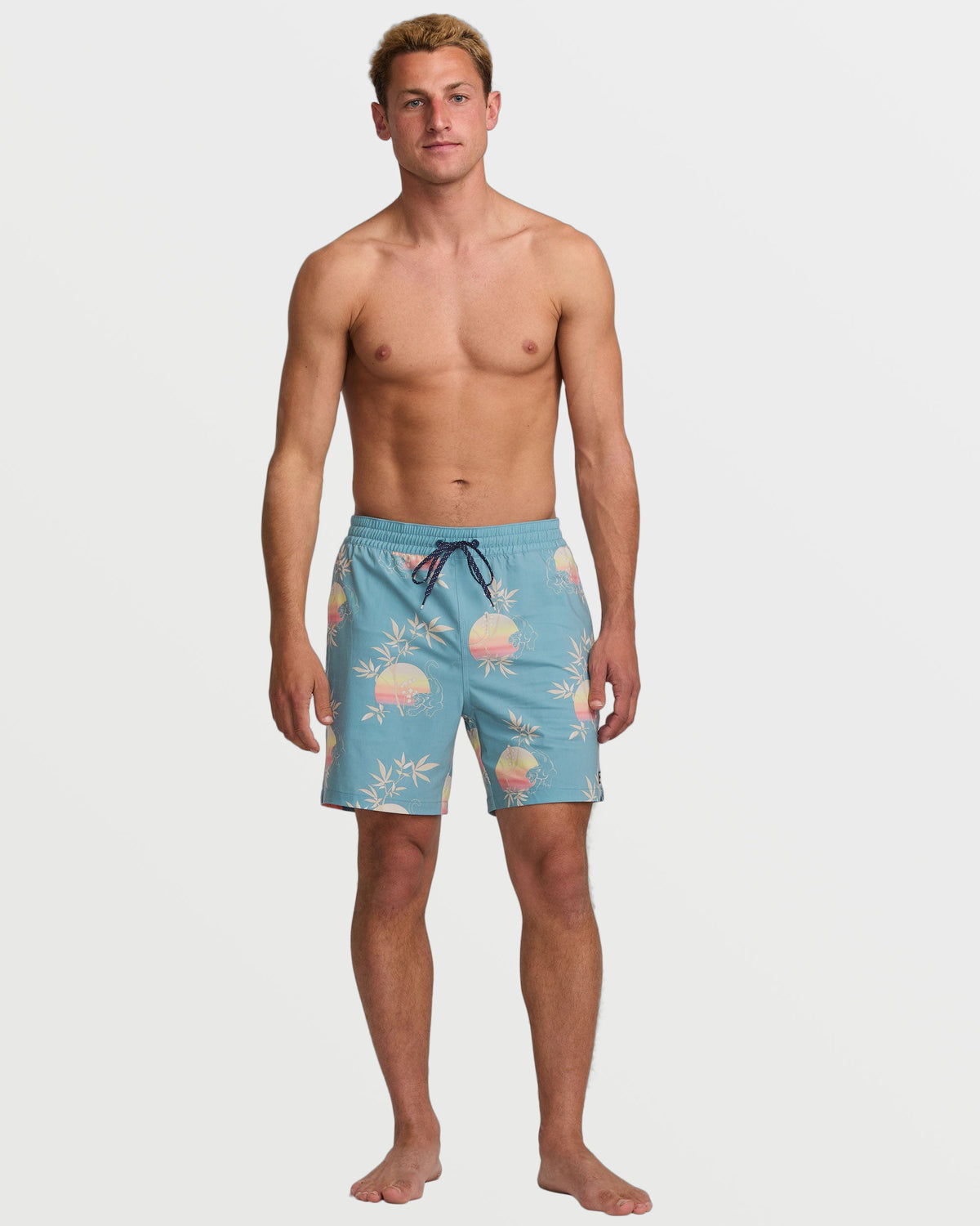 Washed blue 16" swim trunks with sunset and palm leaf print, drawstring waist, knee-length.