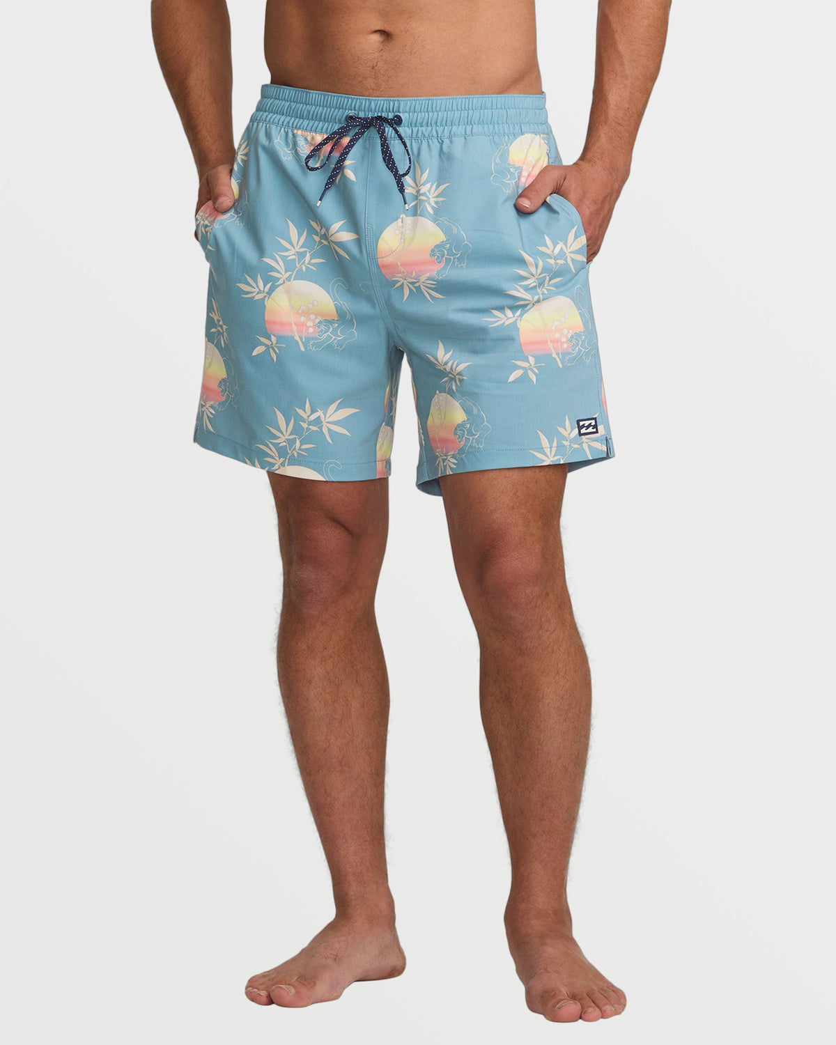 Washed blue swim trunks with sunset and bamboo leaf print, drawstring waist, and side pockets.