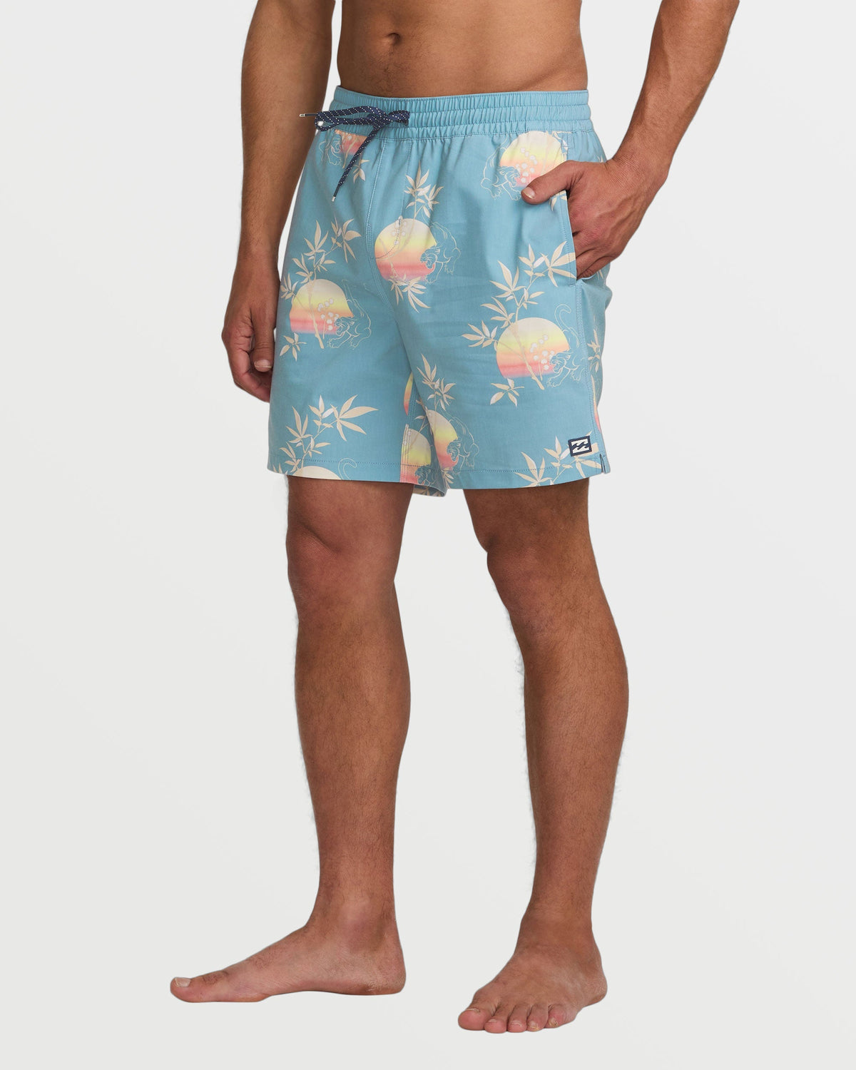 Washed blue swim trunks with sunset and palm leaf print, drawstring waistband, and side pockets.
