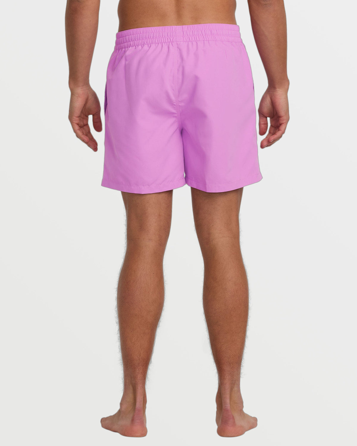 Fuschia swim trunks with elastic waistband and 16-inch inseam on male model, back view.