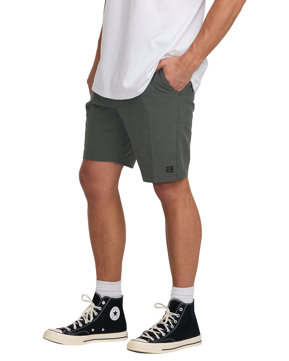 Asphalt gray hybrid shorts with front pockets and small brand logo, worn with white t-shirt and black sneakers.