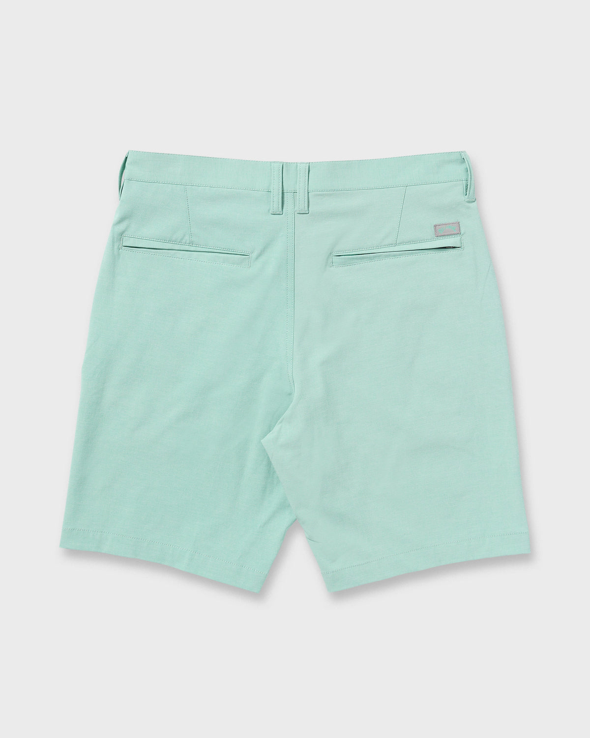 Mint green hybrid shorts with back flap pockets and belt loops, shown from rear view.