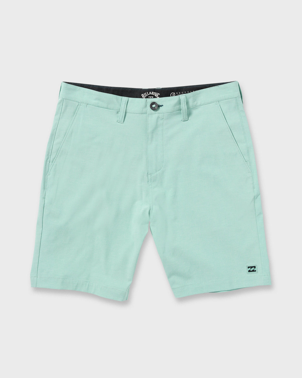 Mint green hybrid shorts with flat front, side pockets, and small logo patch on lower right leg.
