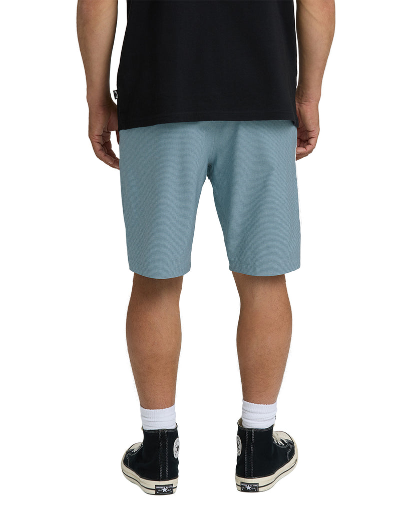 Men's blue fog hybrid shorts with black shirt, viewed from back.