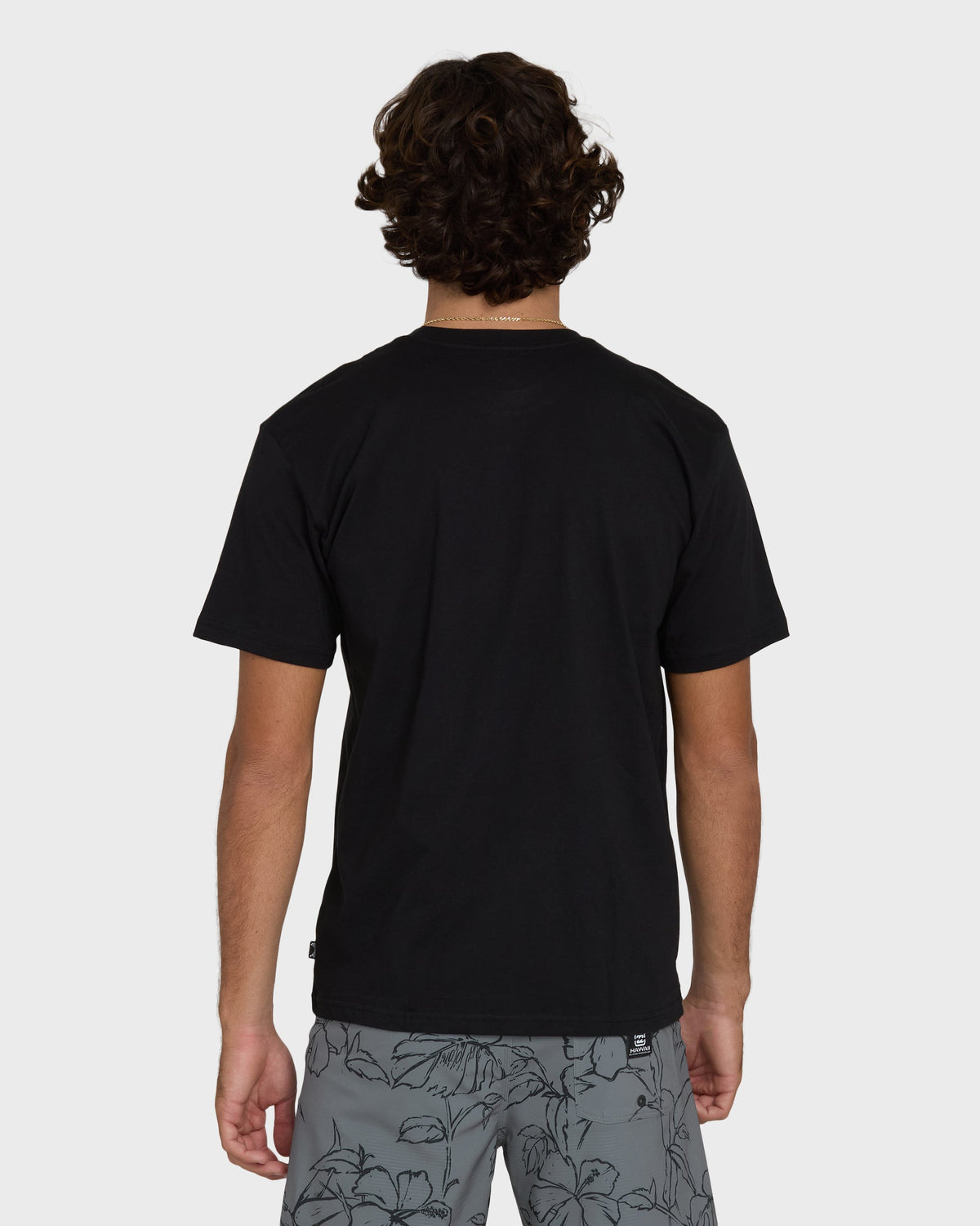 Black short-sleeve crew neck tee displayed on model from back view.