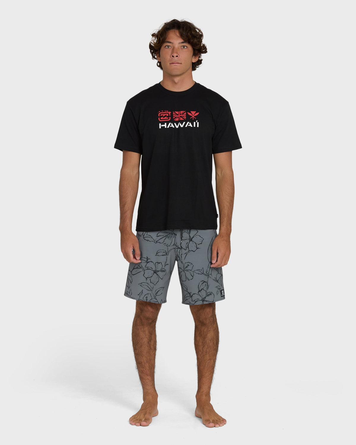 Black short-sleeve t-shirt with "Hawaii" text and decorative symbols printed on chest.