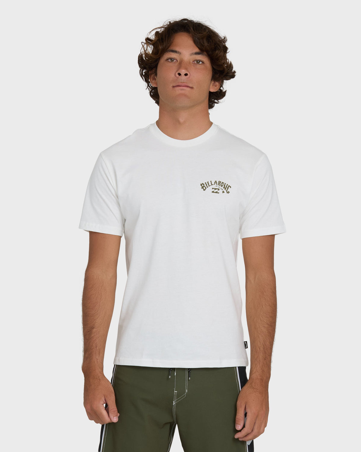 Off-white short sleeve t-shirt with small "Billabong" logo on chest, worn with olive green shorts.