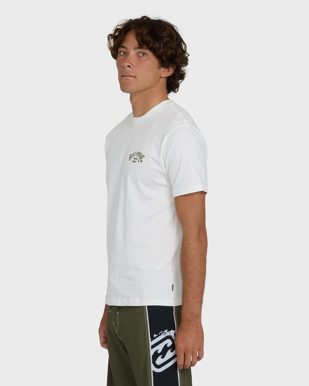 Off-white short-sleeve t-shirt with small chest logo, worn by model with olive and black colorblock shorts.