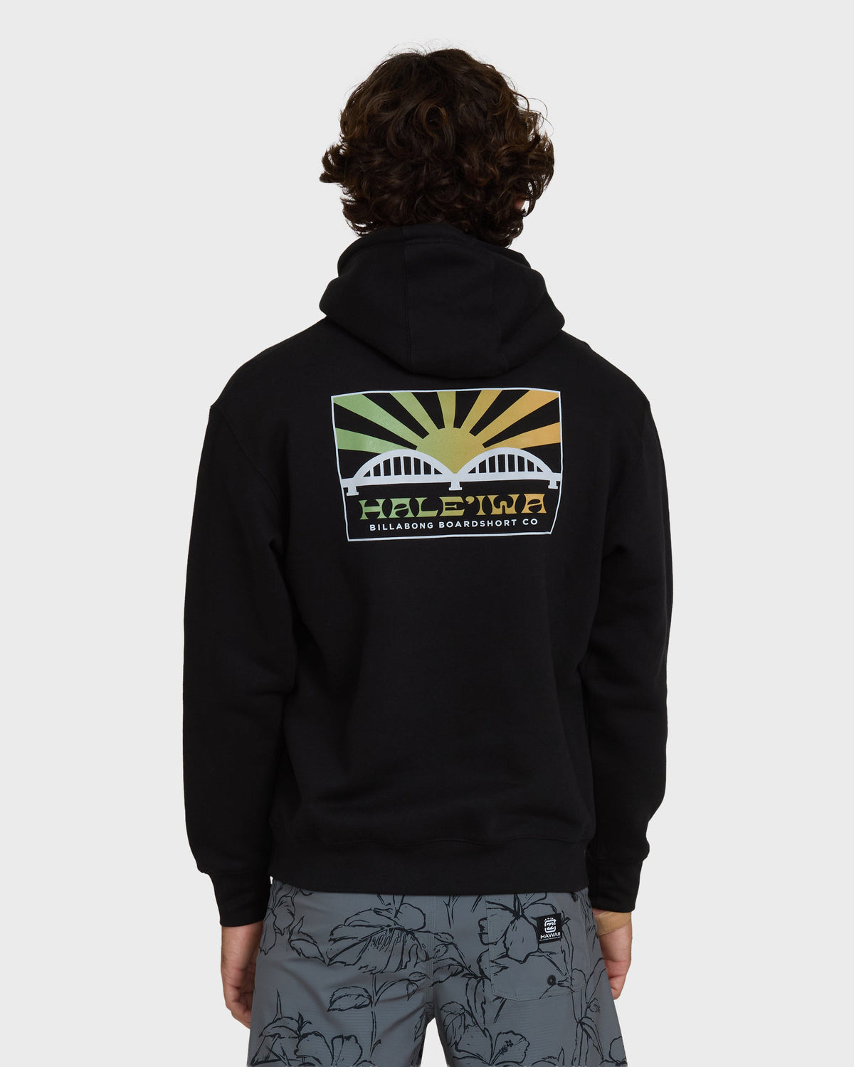 Black pullover hoodie with back graphic featuring rising sun design and "Haleiwa Billabong Boardshort Co" text.