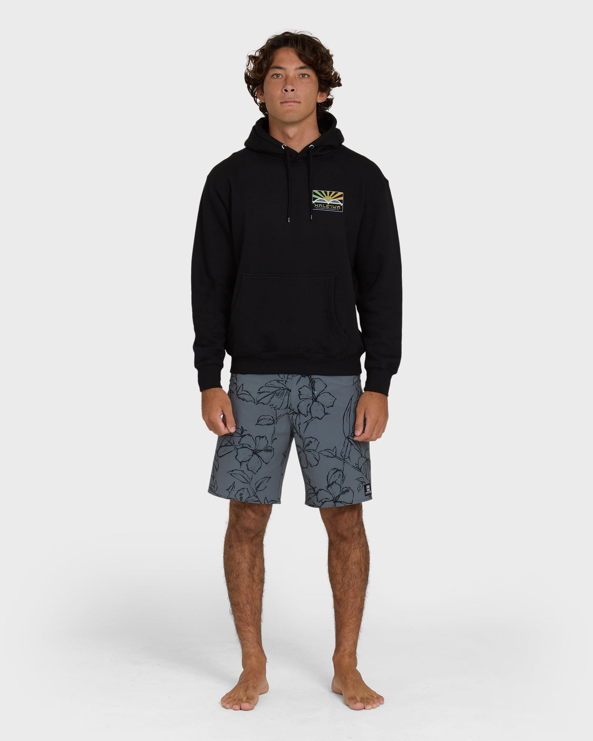 Black pullover hoodie with small sunrise graphic on chest and drawstring hood.