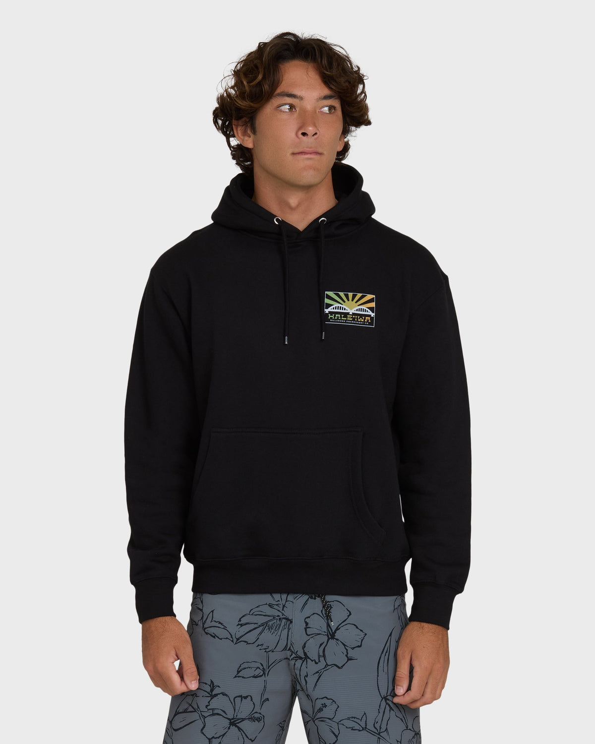 Black pullover hoodie with small rising sun graphic patch on chest and drawstring details.