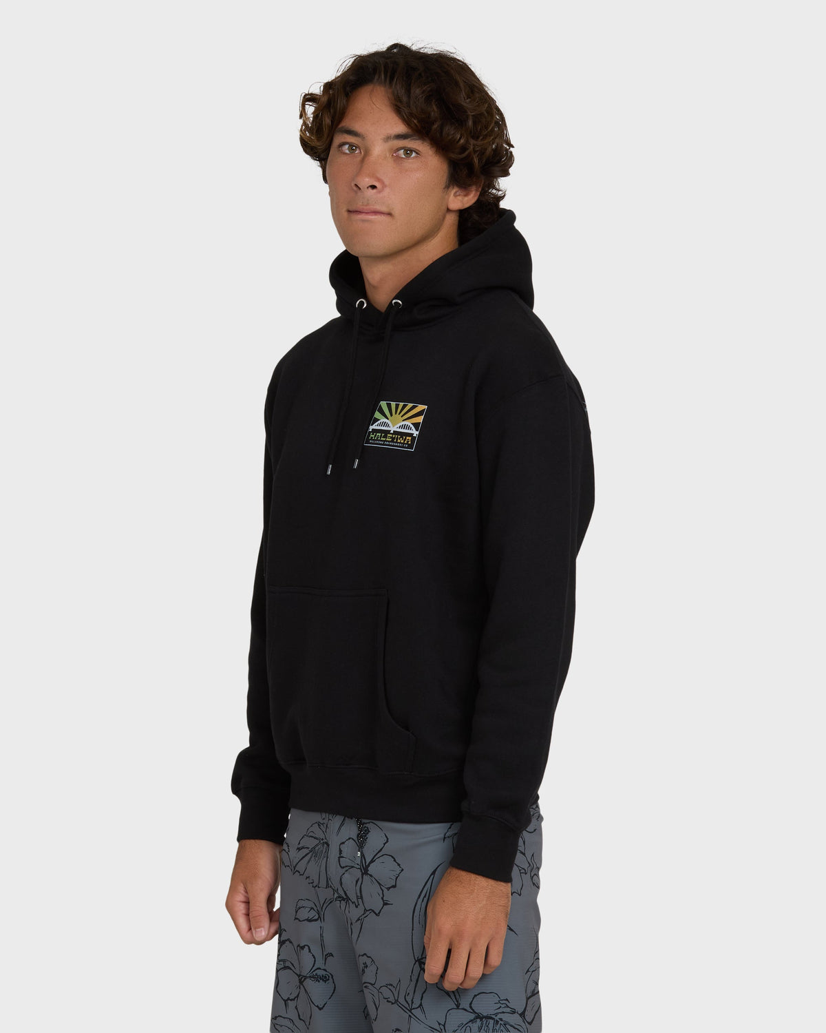 Black pullover hoodie with small rising sun graphic on chest and drawstring hood.