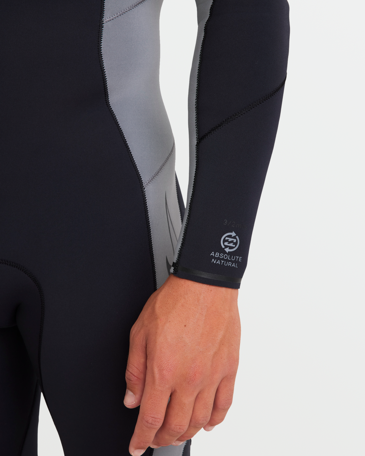 Black and gray neoprene wetsuit sleeve with back zip closure and Absolute Natural branding visible on the cuff.