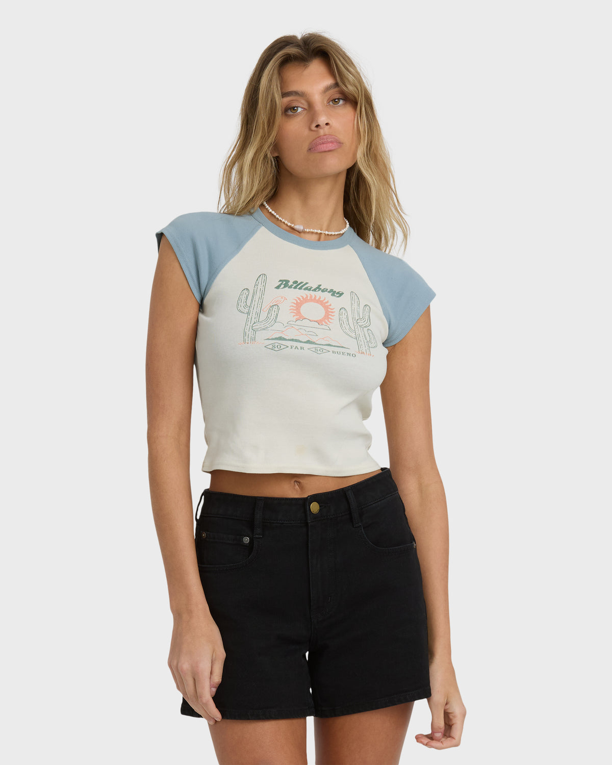 Short sleeve raglan tee in mineral blue and cream with desert graphic print on front.