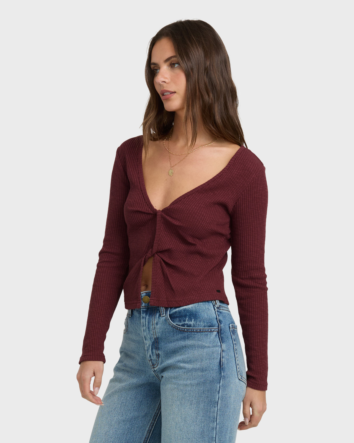 Burgundy ribbed long-sleeve knit top with twisted front detail and V-neckline.