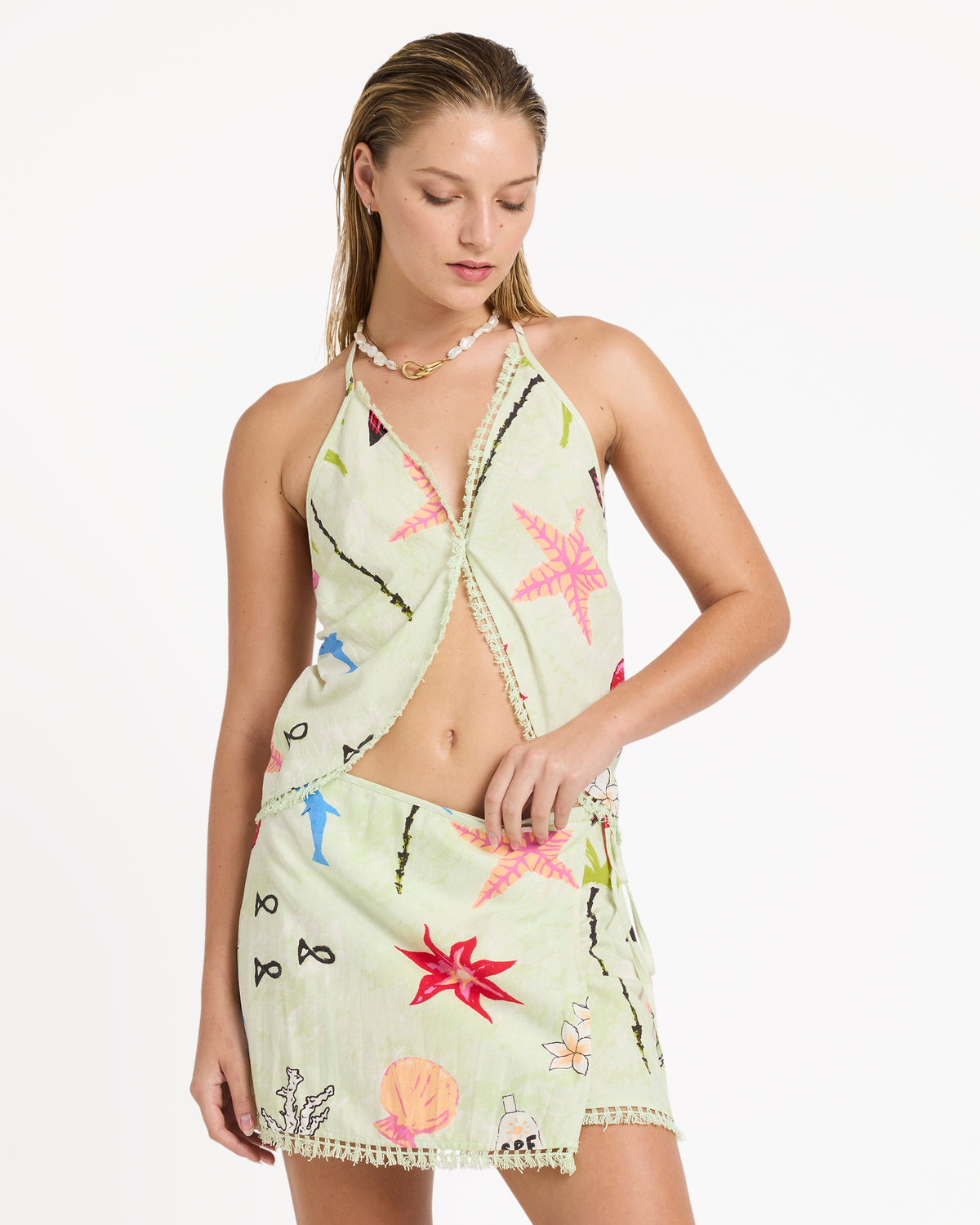 Lime green woven halter tank with colorful embroidered floral and geometric patterns throughout.