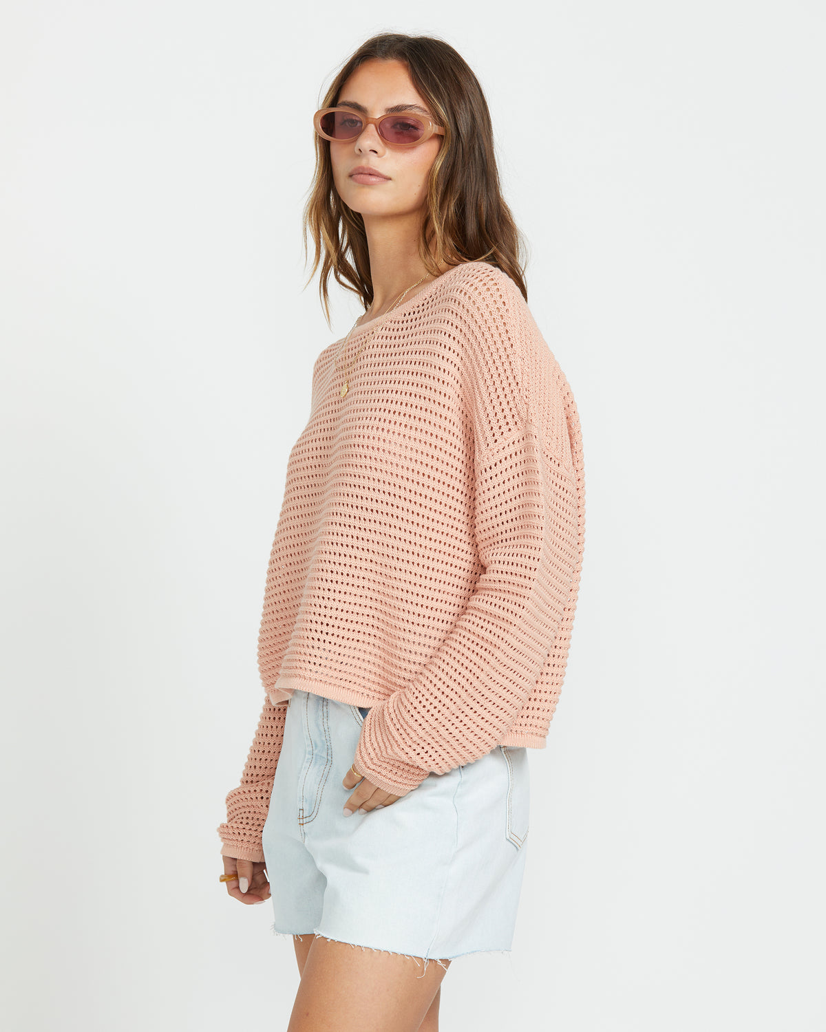 Faded rose textured sweater with open weave pattern worn with light denim shorts.