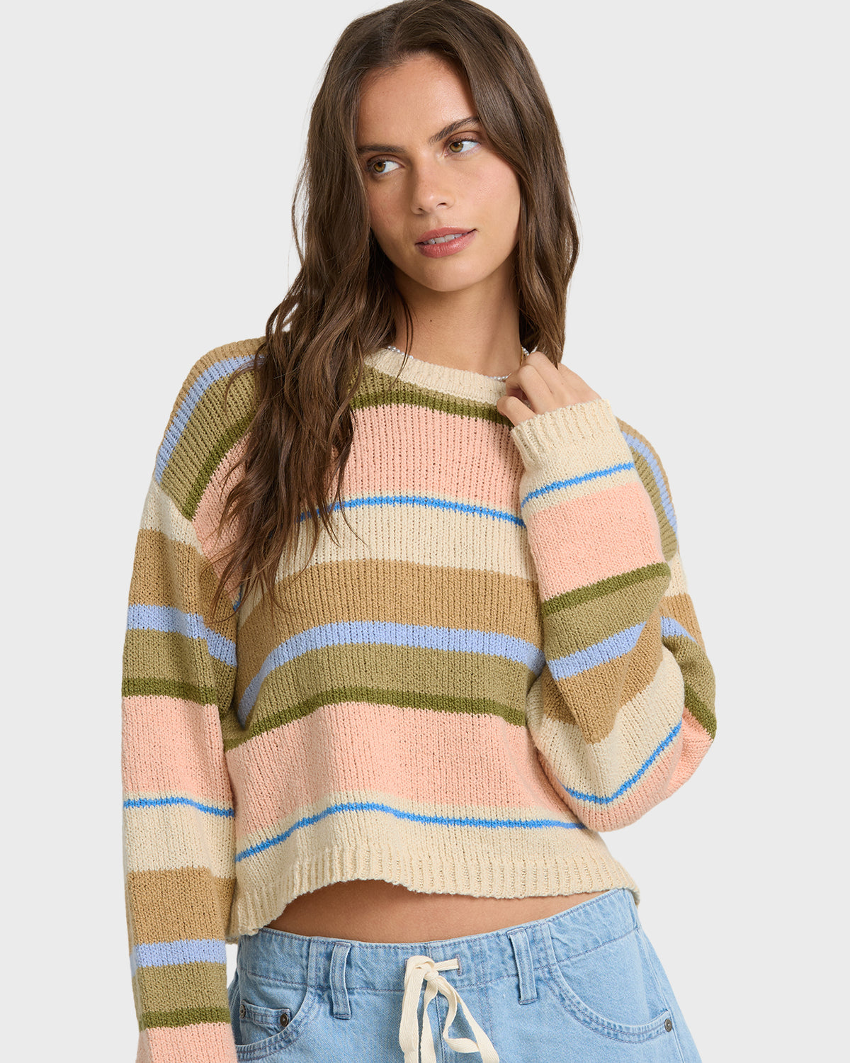 Light peach knit sweater with horizontal stripes in cream, blue, tan, and olive green.