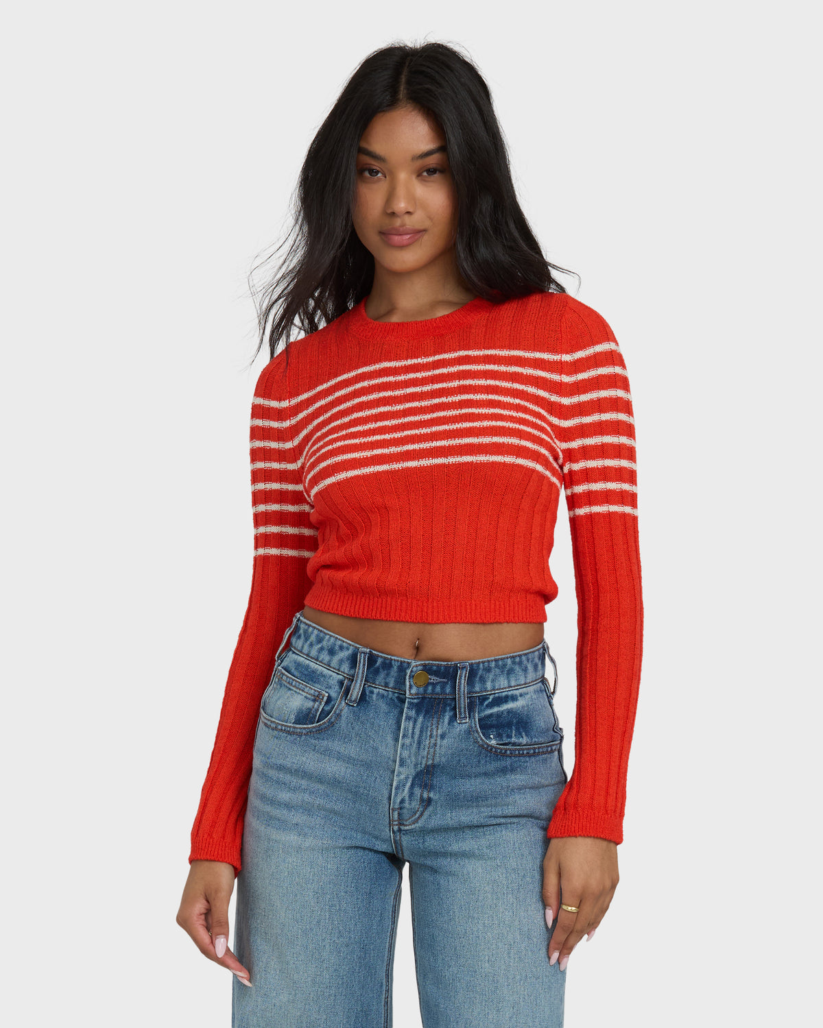 Red ribbed crop sweater with white and cream horizontal stripes across chest and shoulders.