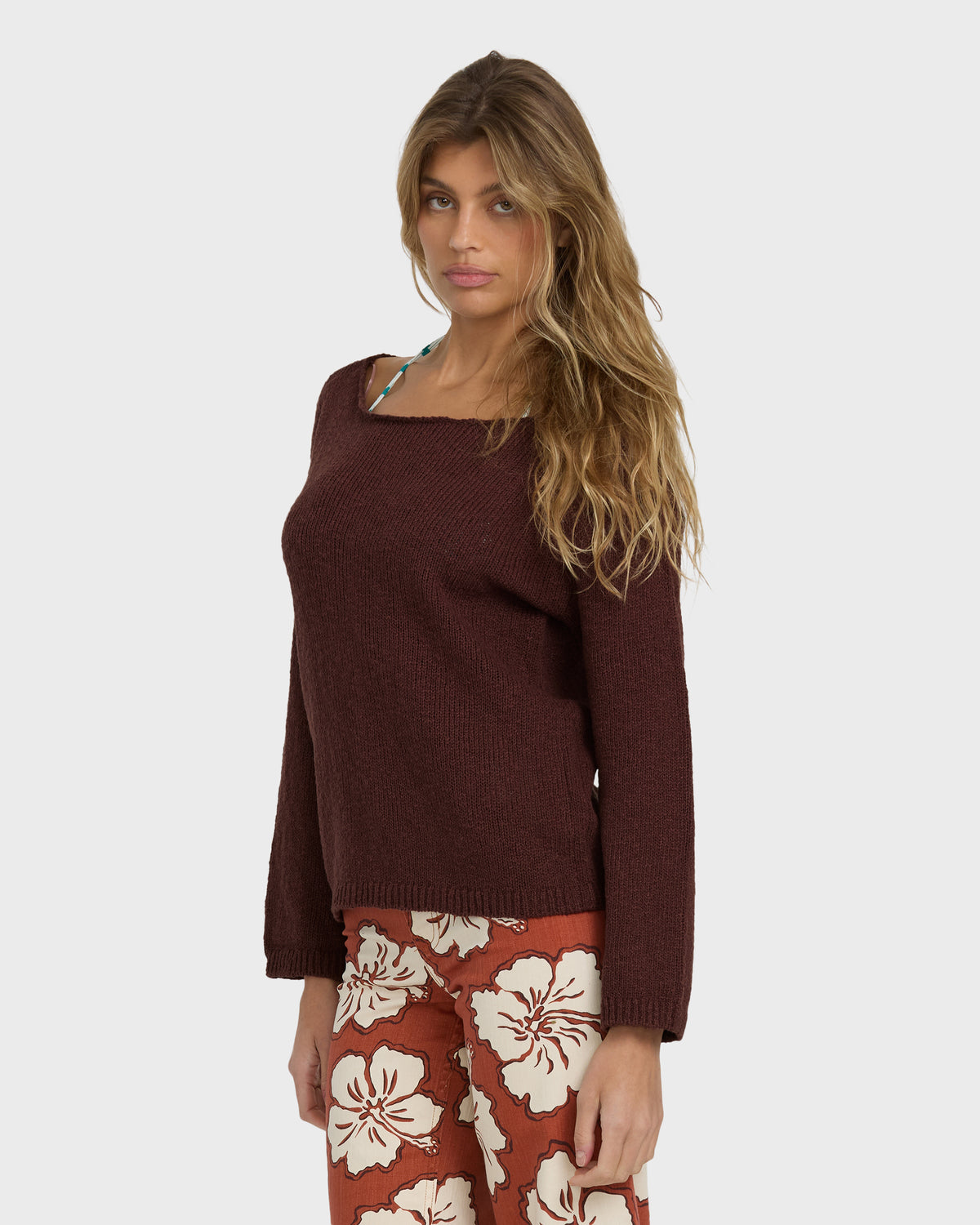 Teak ribbed knit sweater with square neckline and long sleeves on model wearing floral print pants.