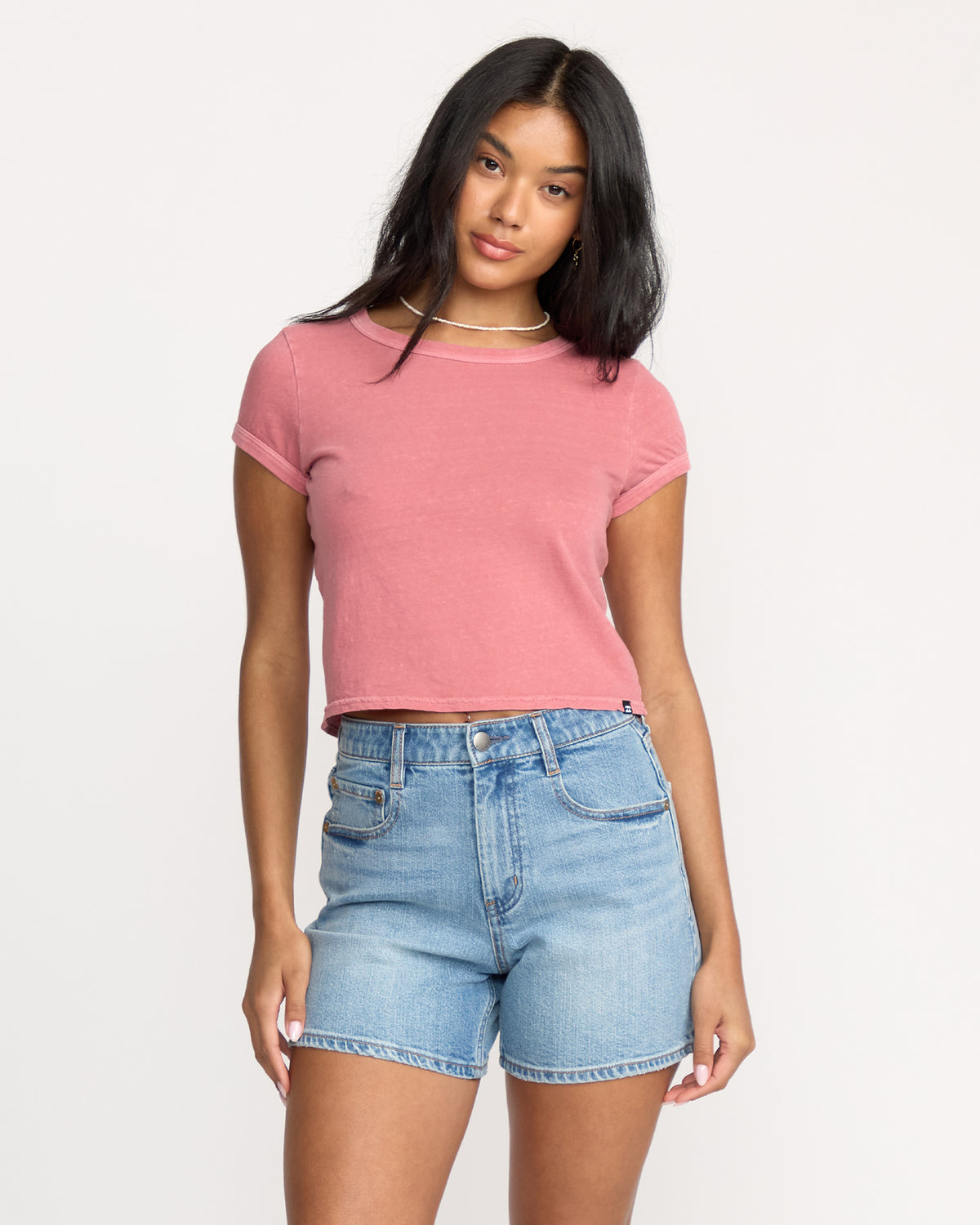 Light blue denim shorts with shaded wash, five-pocket styling, and frayed hem.