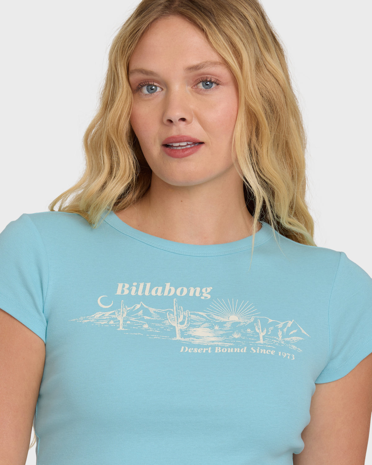 Laguna blue short sleeve t-shirt with cream-colored desert graphic and "Billabong Desert Bound Since 1973" text.