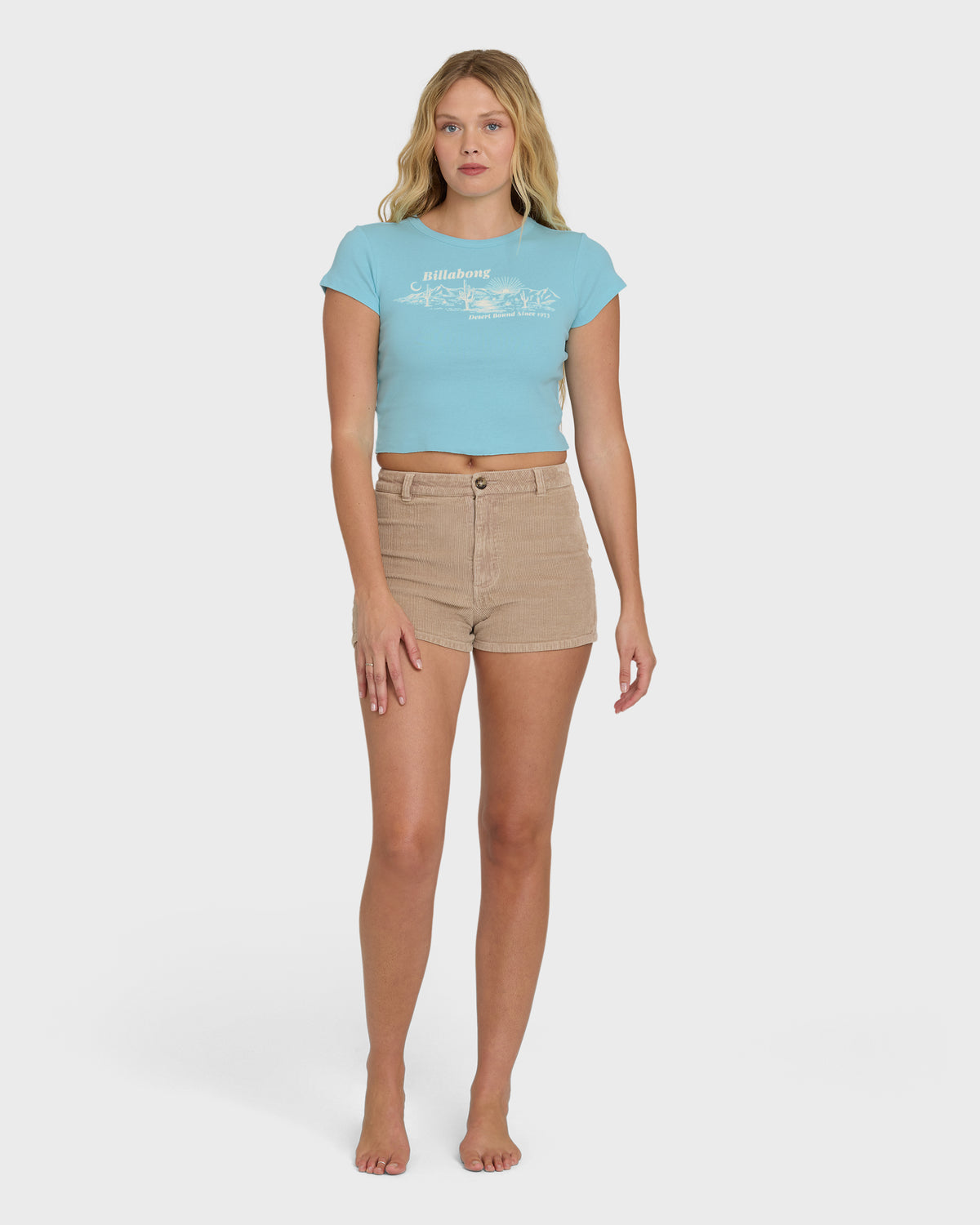 Laguna blue short sleeve t-shirt with white graphic print worn with tan shorts.