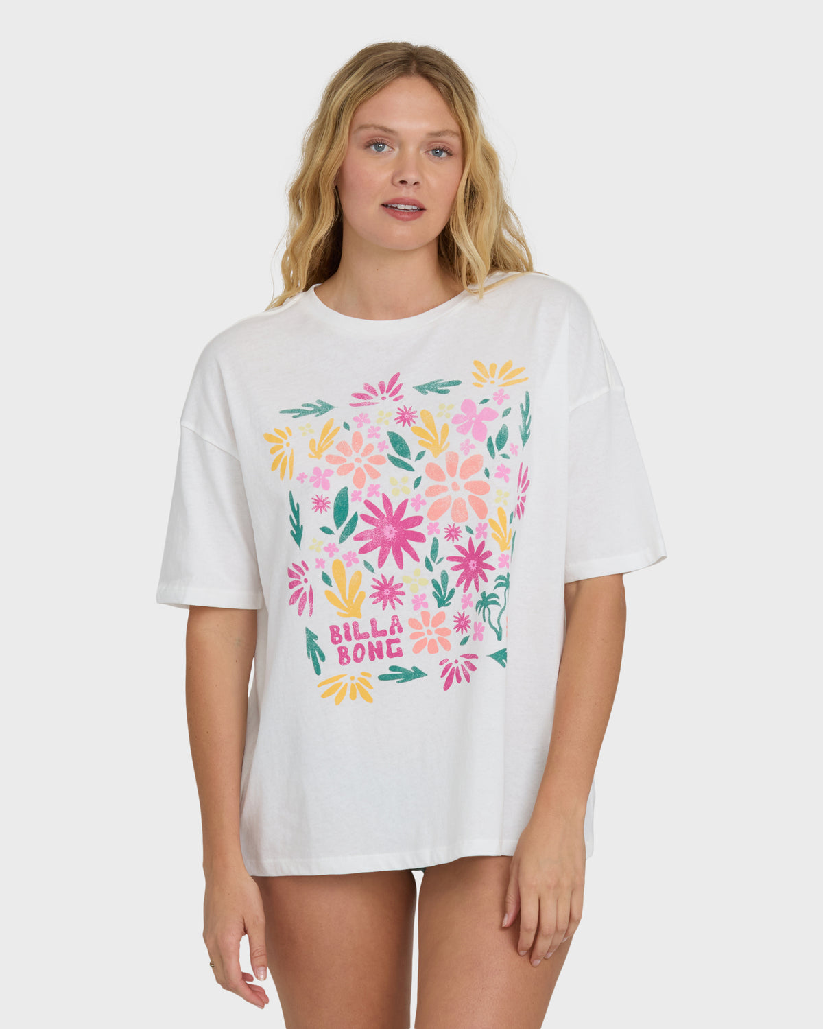 Cream short-sleeve t-shirt with colorful floral and leaf print design in pink, yellow, and teal.