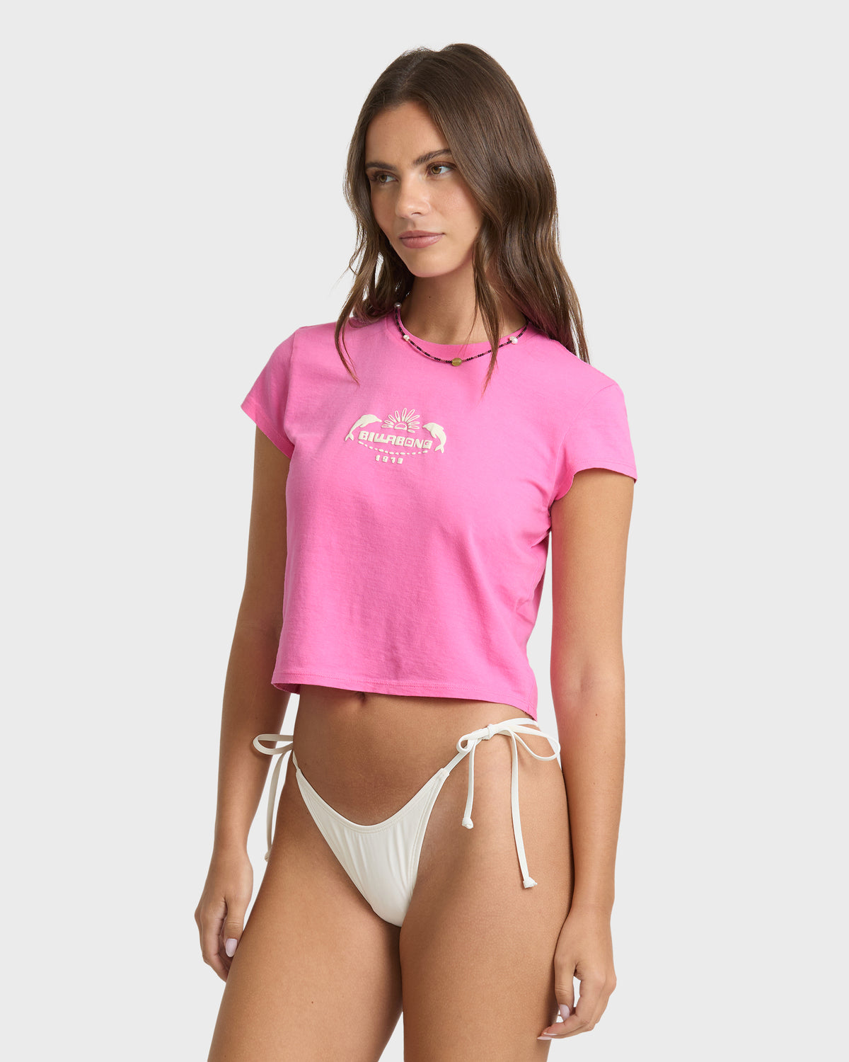 Guava pink short-sleeve t-shirt with graphic print on chest, worn with white bikini bottom.
