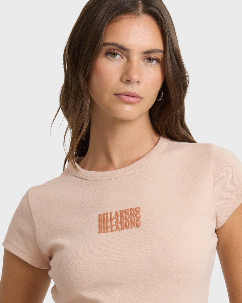 Oatmeal short-sleeve t-shirt with embroidered text graphic on chest, worn by model against white background.
