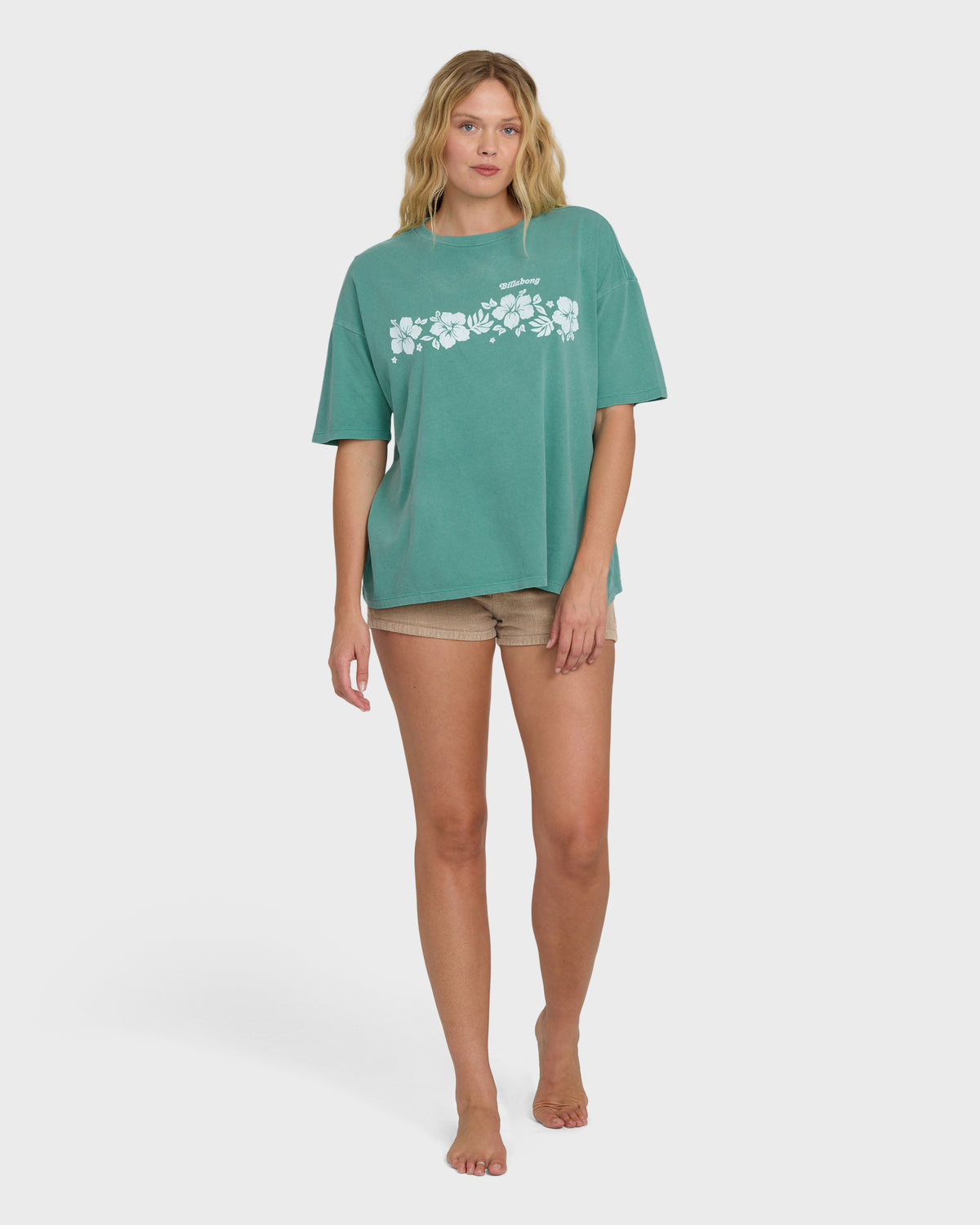 Island green short sleeve t-shirt with white floral graphic print across chest.