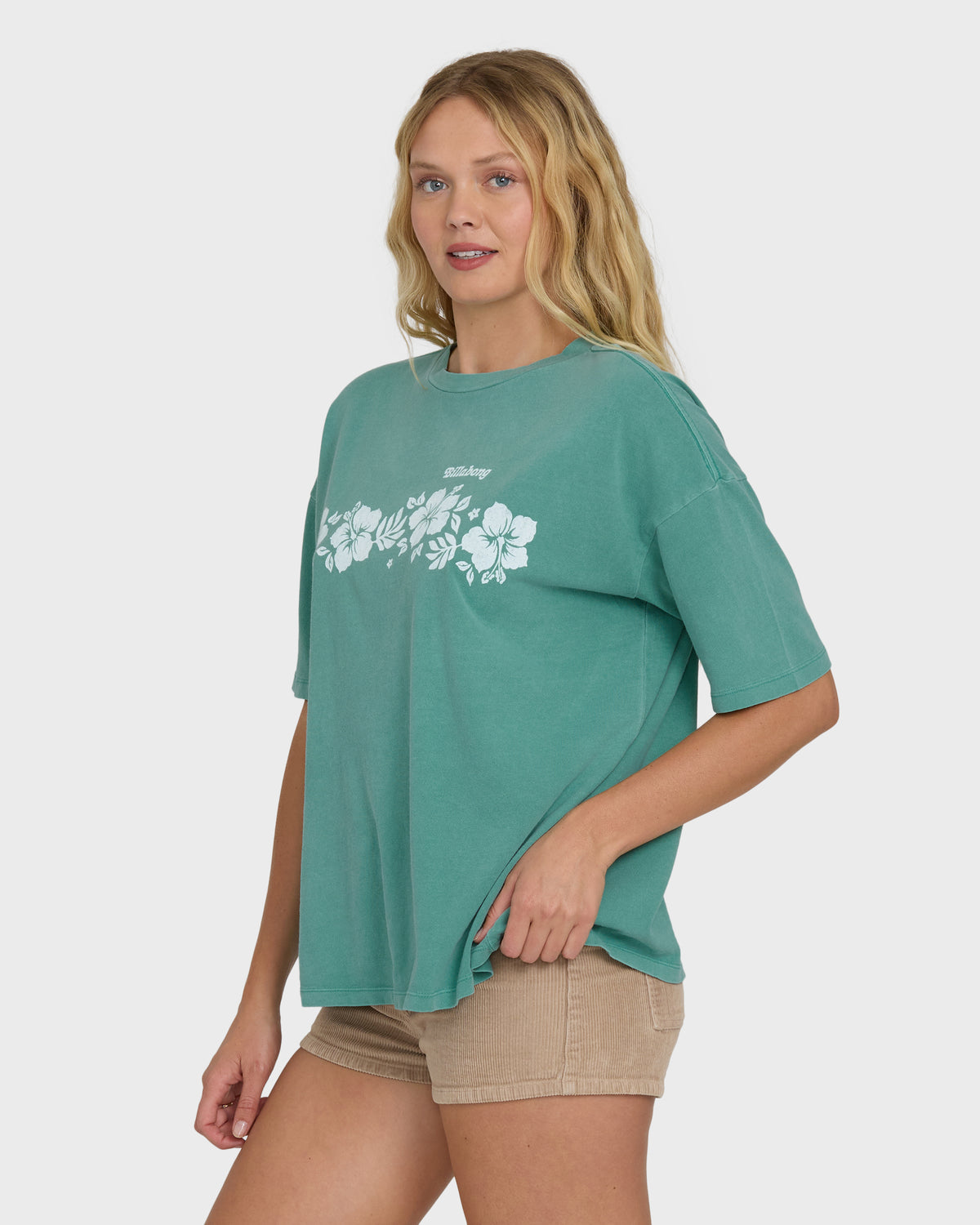 Island green short sleeve t-shirt with white floral graphic on chest.