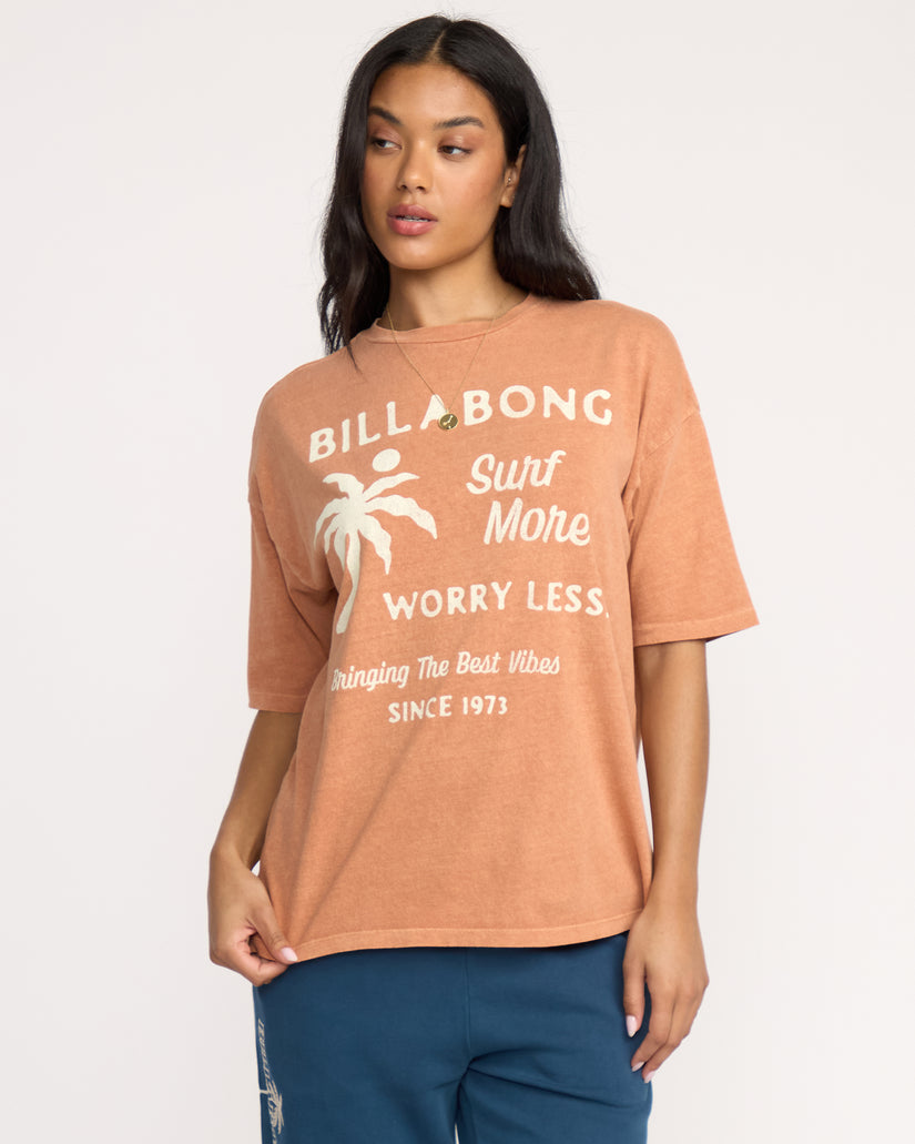 Sunburnt short sleeve tee with white Billabong text, palm tree graphic, and "Surf More Worry Less" design.